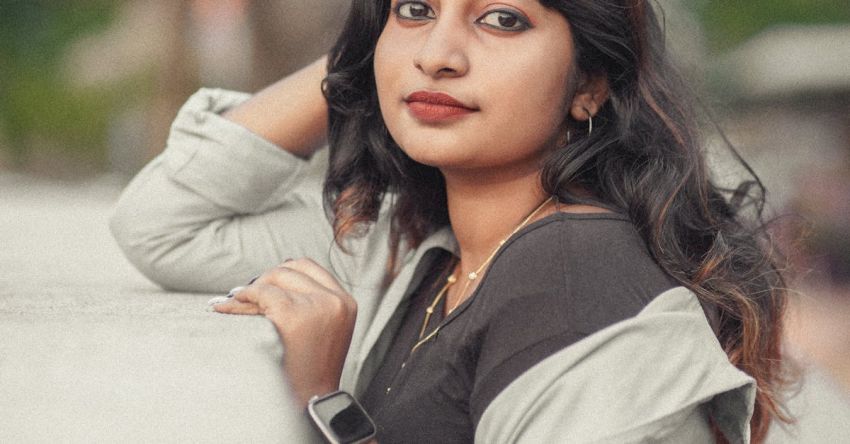 Smartwatches - A young woman leaning against a wall